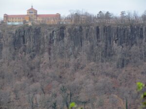 A view of trees and cliffs from the top of a cliff.