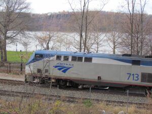A train is on the tracks near some water.
