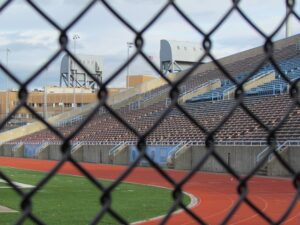 A baseball field with many empty bleachers.