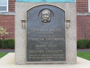 A plaque with a face on it in front of a building.