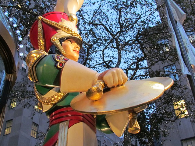 A statue of a man holding a plate in his hand.