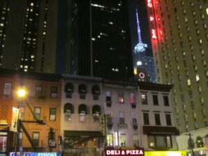 A city street with buildings lit up at night.