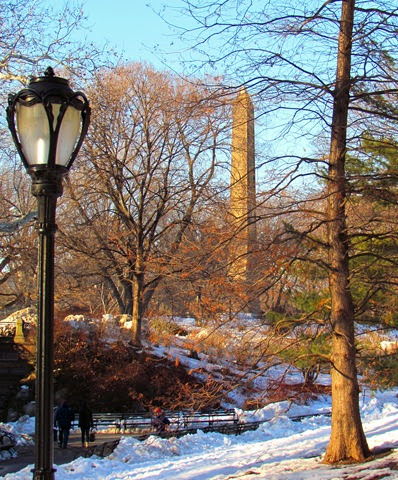 A lamp post in the middle of a park