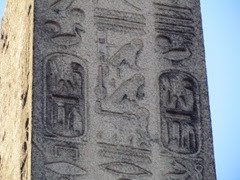 A close up of the egyptian hieroglyphs on a stone pillar