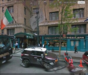 A street view of a car parked on the side of a road.