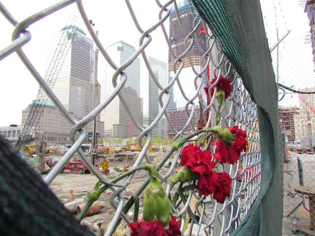 A fence with flowers growing on it