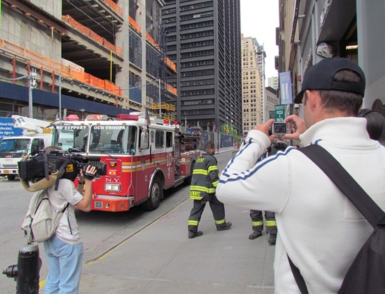 A man taking a picture of a fire truck.