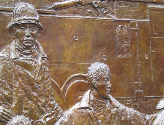 A close up of the bronze relief on the wall
