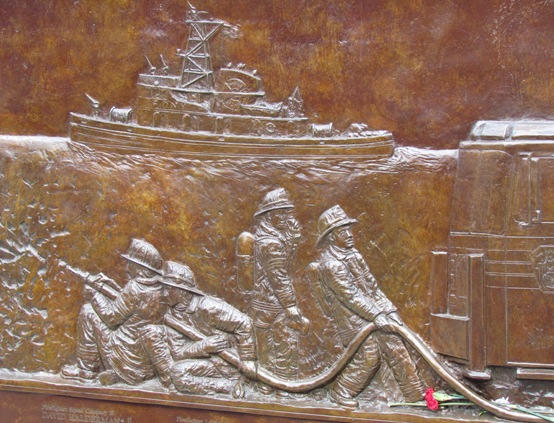 A bronze sculpture of soldiers in the water.