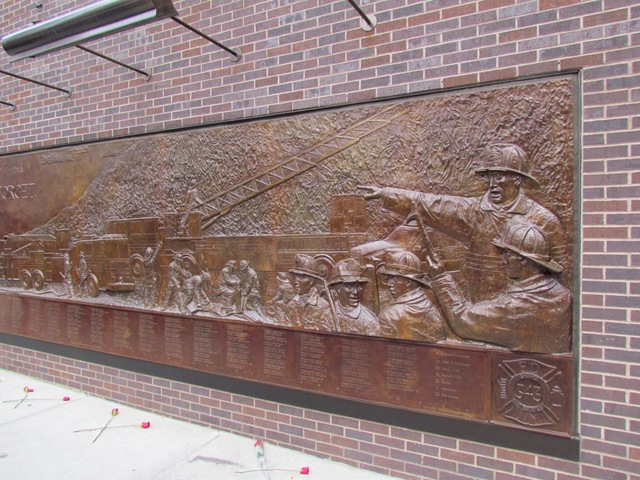 A bronze plaque of soldiers in the army.