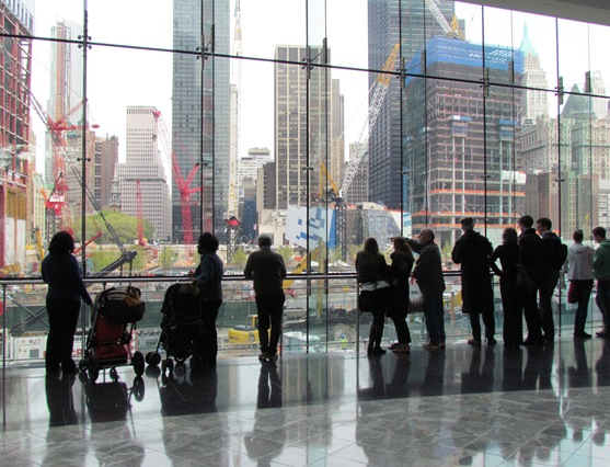 A group of people standing in front of a window.
