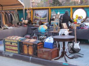 A group of old trunks and tables on display.