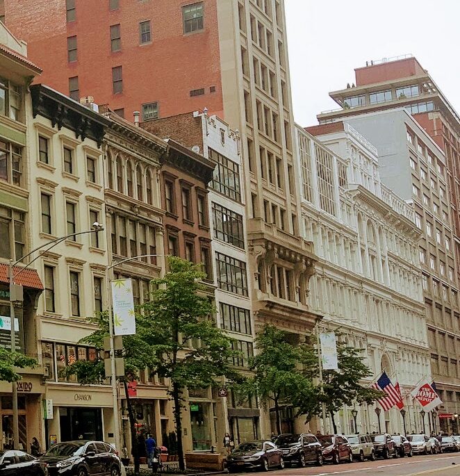 A city street with many buildings and trees
